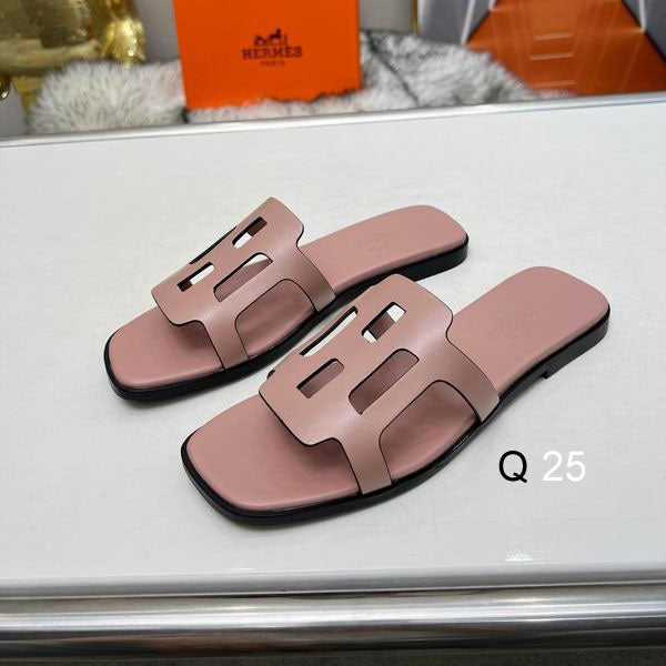 Blush pink H-strap flat slide sandals on white surface
